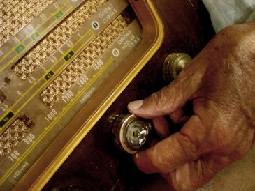 This photo of a gentleman of the "radio generation" tuning the dial on his radio ... looking for that favorite station ... was taken by Marcelo Brito Filho from Uberaba, Brazil.